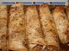 Apple enchiladas filled with apple pie filling and baked in brown-sugar butter syrup