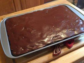 Hershey’s syrup brownies with a fudgy cocoa icing spread over chocolate sheet brownies