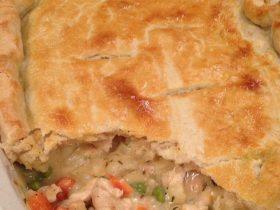 Creamy chicken pot pie casserole with potatoes, vegetables, and golden pie crust