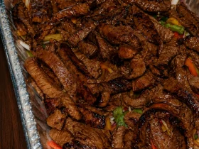 Spicy steak fajitas with seared beef, bell peppers, and onions