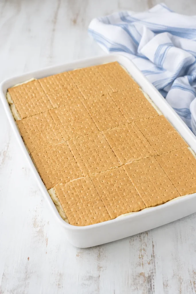 layered no-bake chocolate eclair cake in a baking dish