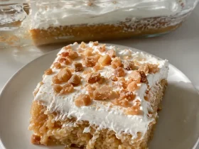 Toffee butterscotch cake topped with whipped topping and toffee bits