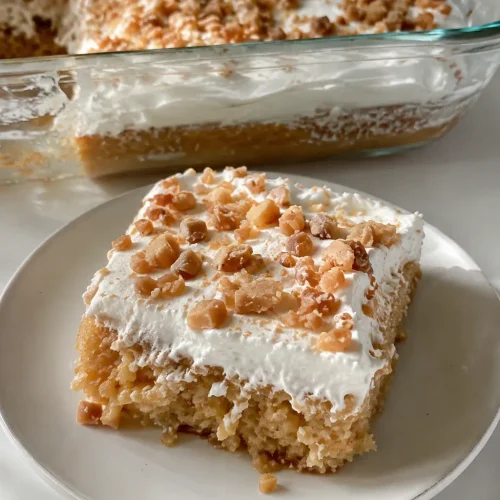 Toffee butterscotch cake topped with whipped topping and toffee bits