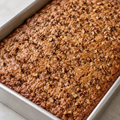 Baked Sweet Alabama Pecan Bread with chopped pecans in a rectangular metal pan