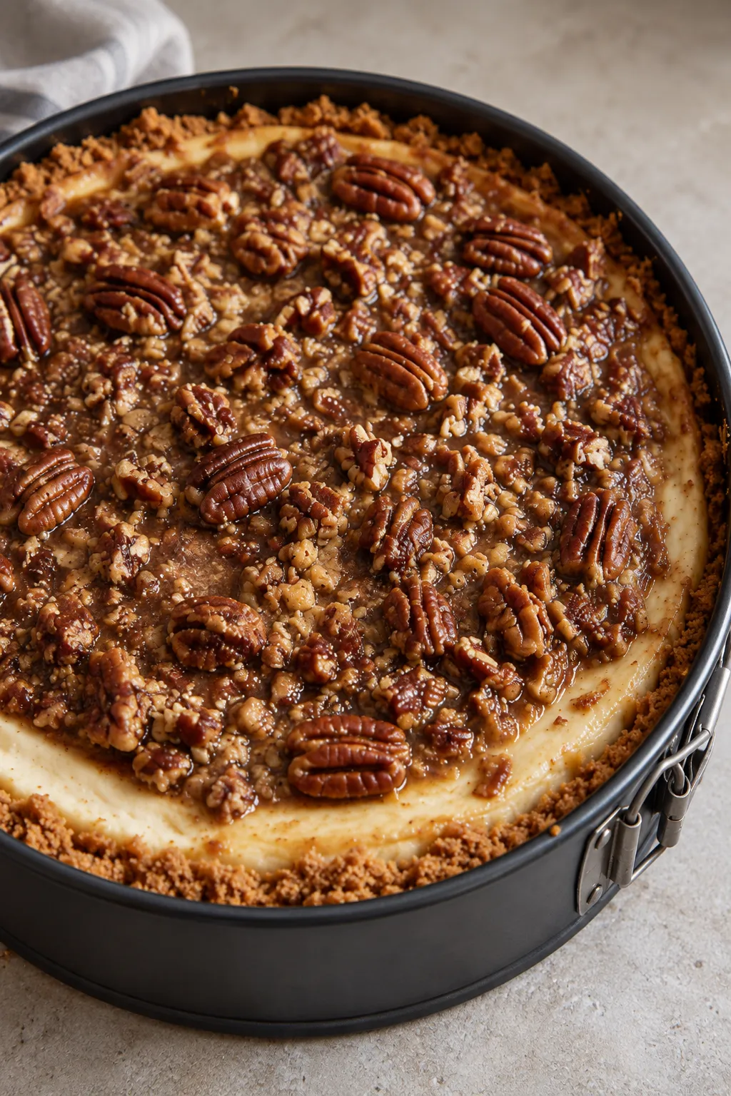 Overhead view of pecan cheesecake pie with caramel pecans