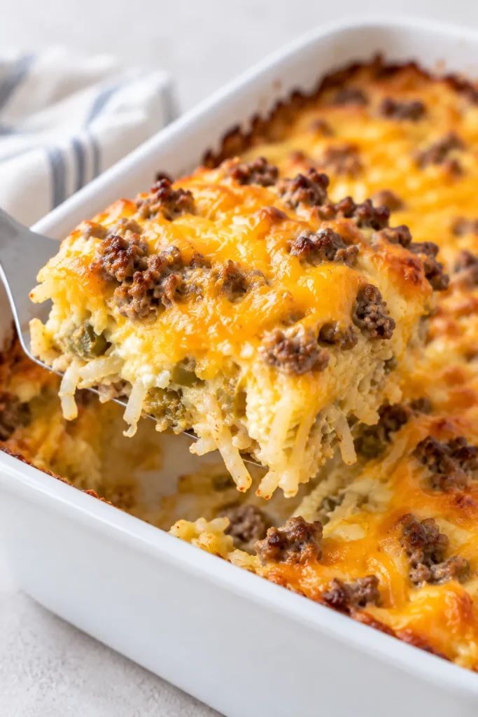 Slice of sausage hash brown breakfast casserole lifted from baking dish