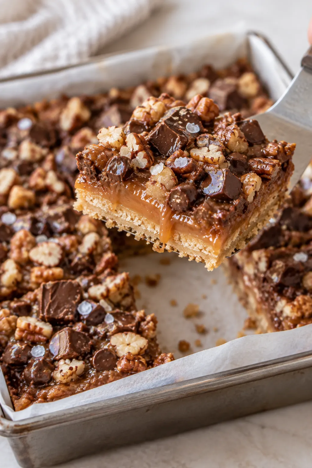 Cut chocolate caramel bars showing a buttery crust and thick caramel layer