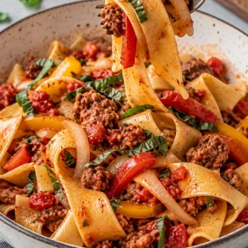 Italian Drunken Noodles with pappardelle, Italian sausage, bell peppers, tomatoes, and herbs