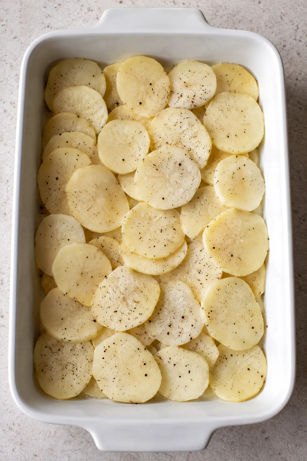 Cheesy hamburger potato casserole serving lifted from the baking dish showing beef and potato layers