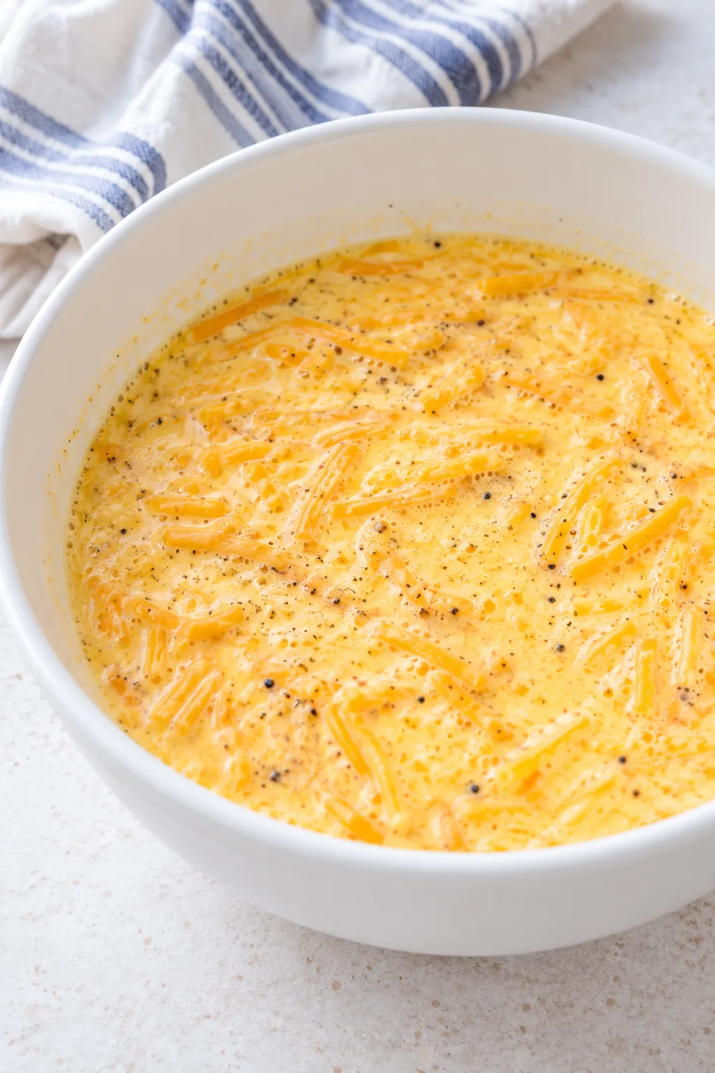 Egg, heavy cream, cheddar, salt, and pepper mixture for bacon cheeseburger casserole
