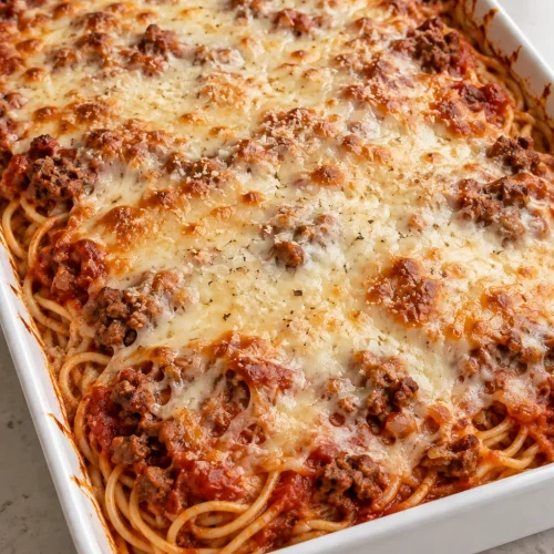 Baked cream cheese spaghetti with beef marinara and a lightly golden cheese topping.