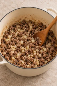 Softened onion and minced garlic mixed with the browned beef.