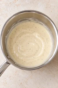Smooth creamy milk and ranch sauce in a small saucepan before adding it to the chicken