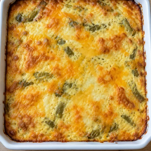 Golden Jack and cheddar cheese across the top of an uncut green chile casserole