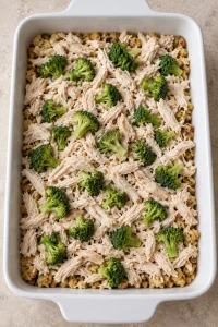 Shredded chicken and thawed broccoli layered over the buttered stuffing base.