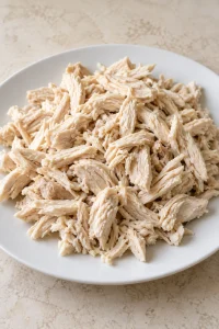 Cooked chicken breasts shredded into bite-size pieces for the casserole.