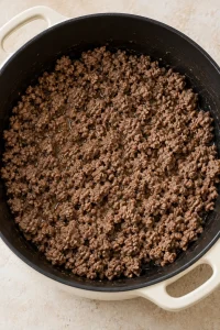 Ground beef browned in a soup pot for pasta fagioli.