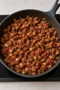 Garlic and tomato paste stirred through browned beef and onion