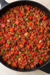 Beef and bell peppers stirred with diced tomatoes and tomato sauce.