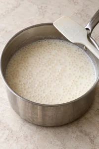 Small tapioca pearls cooking gently in milk.