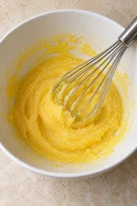 Egg yolks whisked with granulated sugar.