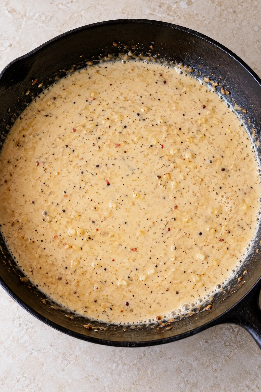 Heavy cream stirred into the garlic and broth to start the pan sauce.