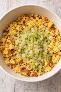 Cooked onion and celery added to crumbled cornbread