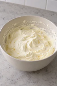 Thick vanilla pudding and whipped cream filling in a mixing bowl