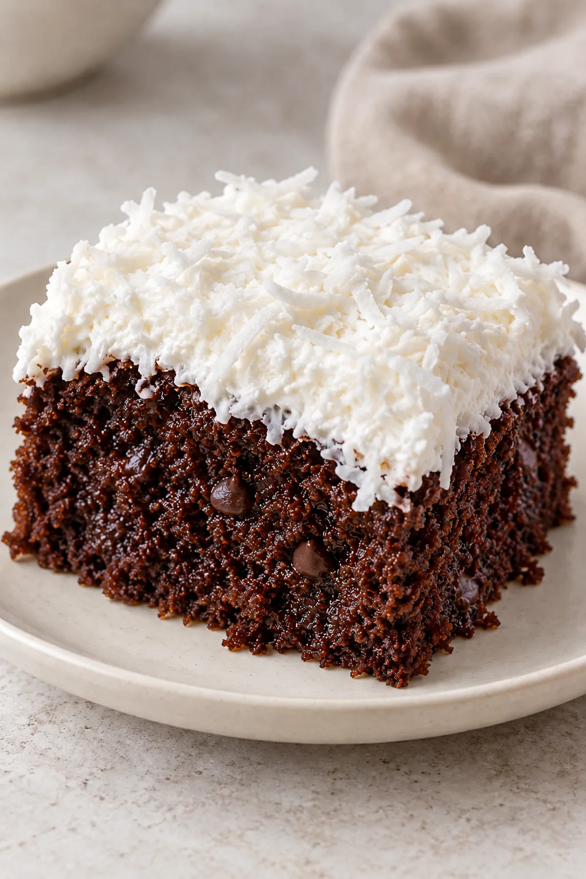 Slice of chilled Mounds cake showing chocolate crumb and coconut topping