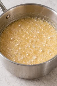 Pale sugar butter and evaporated milk mixture bubbling steadily during the five-minute boil