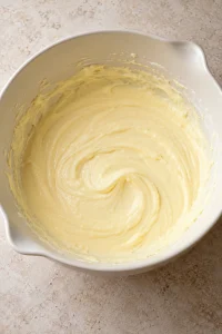 Cream cheese mixed with eggs and vanilla before adding sugar