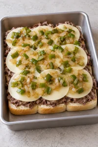Shaved roast beef, overlapping provolone slices, and sautéed peppers and onions layered on the bottom rolls