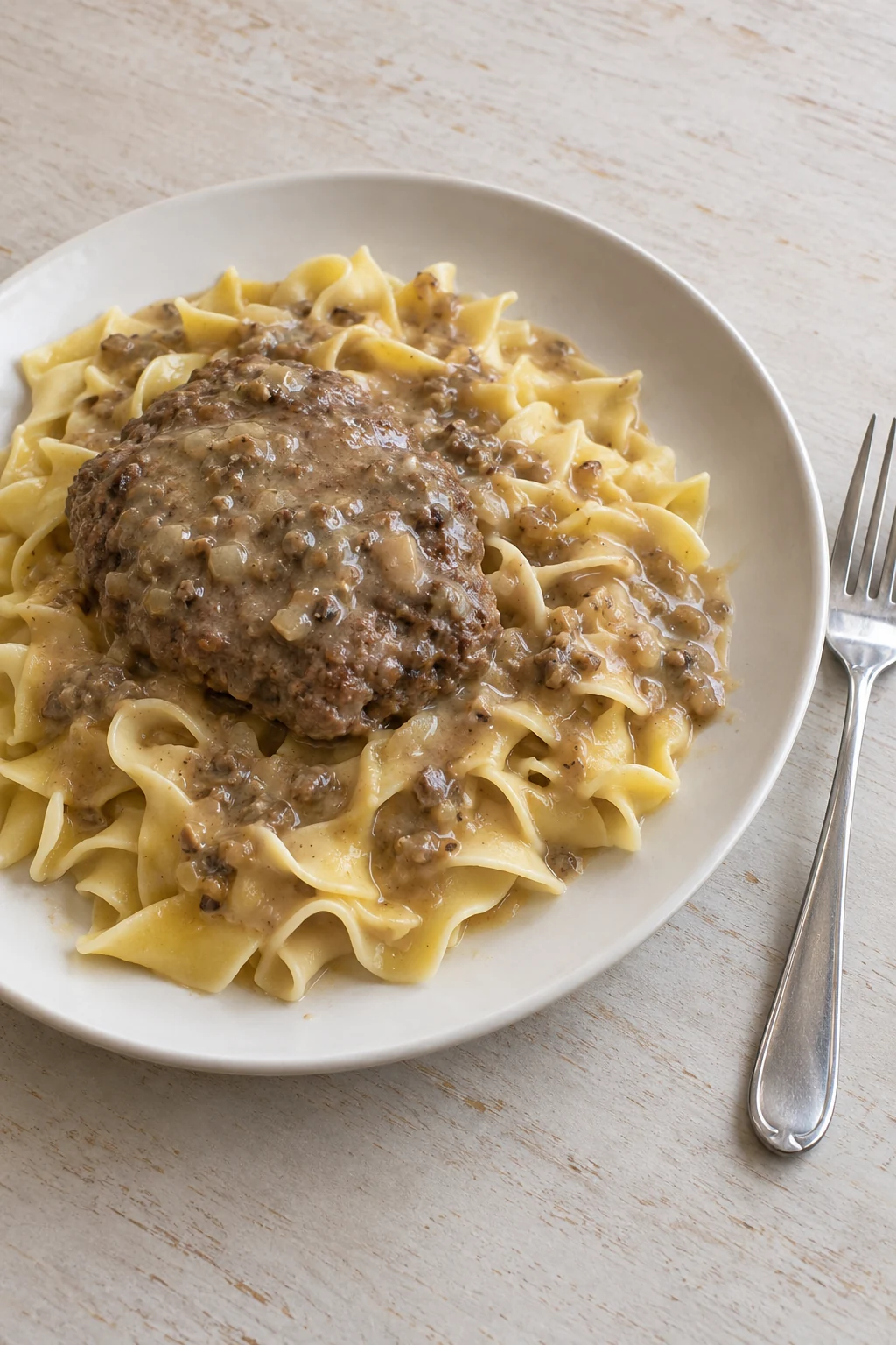 Hamburger steak and mushroom-onion gravy served over wide egg noodles
