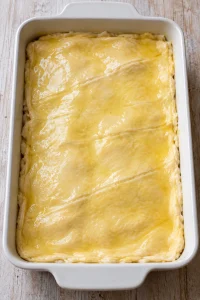 Melted butter spread over the upper crescent dough sheet.