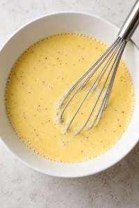 Whisked eggs and milk with garlic powder, onion powder, salt, and black pepper