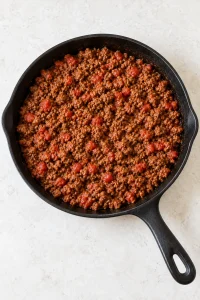 Browned beef simmered with taco seasoning and diced tomatoes